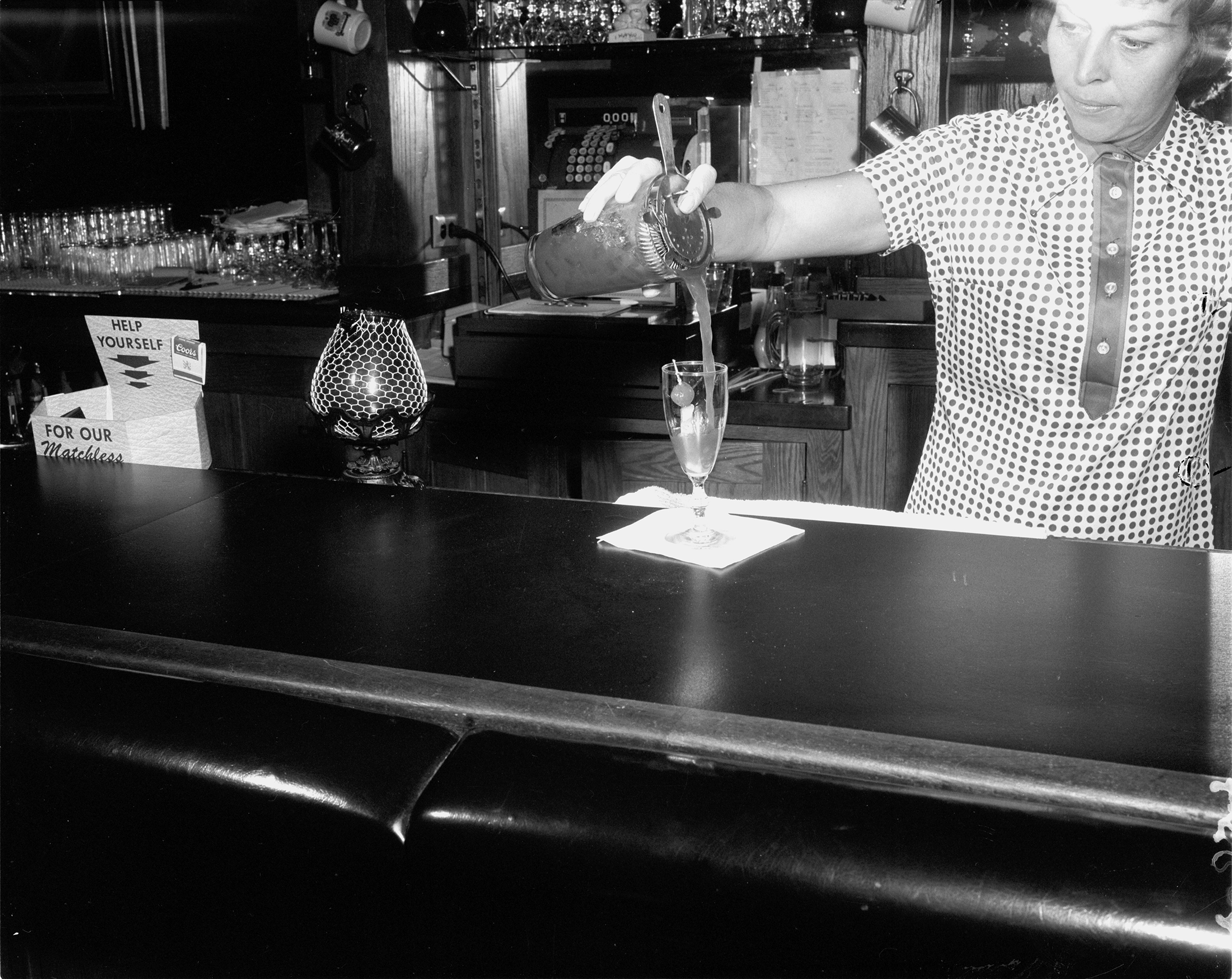 Jinx's Place - Jinx Clark Pouring a Drink - PPLD Digital Collections - Photo by Stanley Payne.png